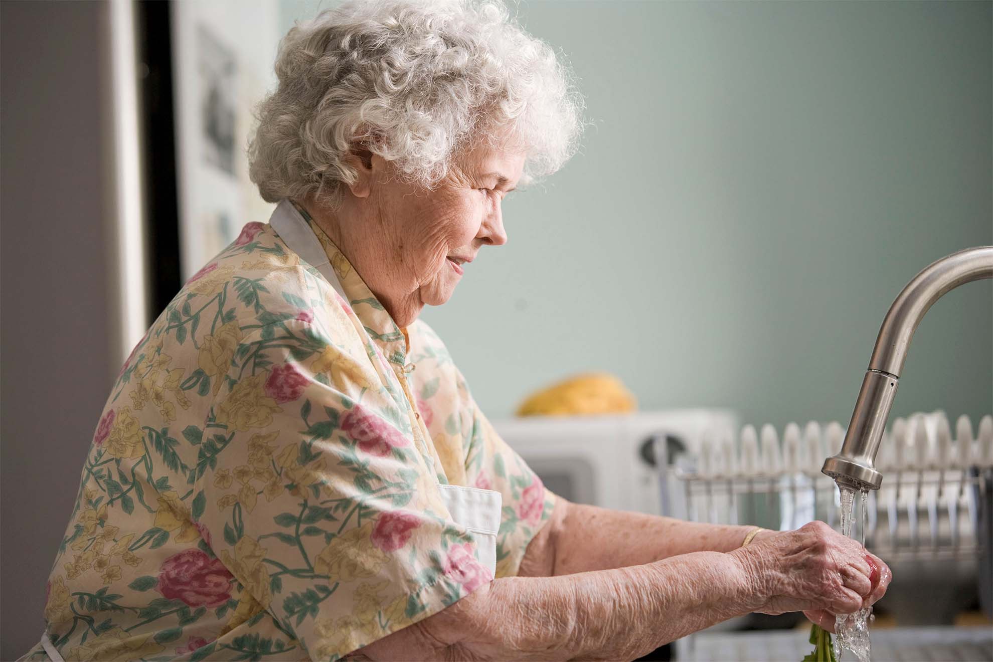 older lady washing her hands